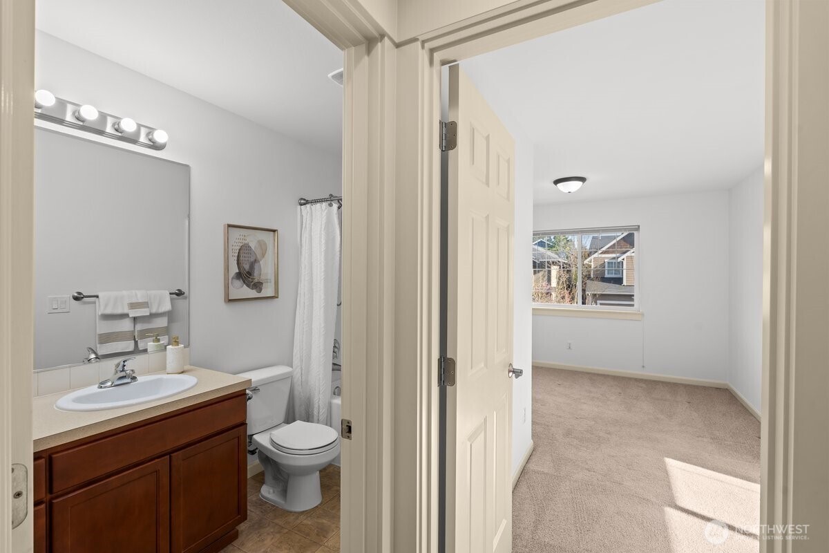 603 194th Place Southeast Bothell, WA 98012 - Photo 22 of 30 a bathroom with a toilet a sink and mirror