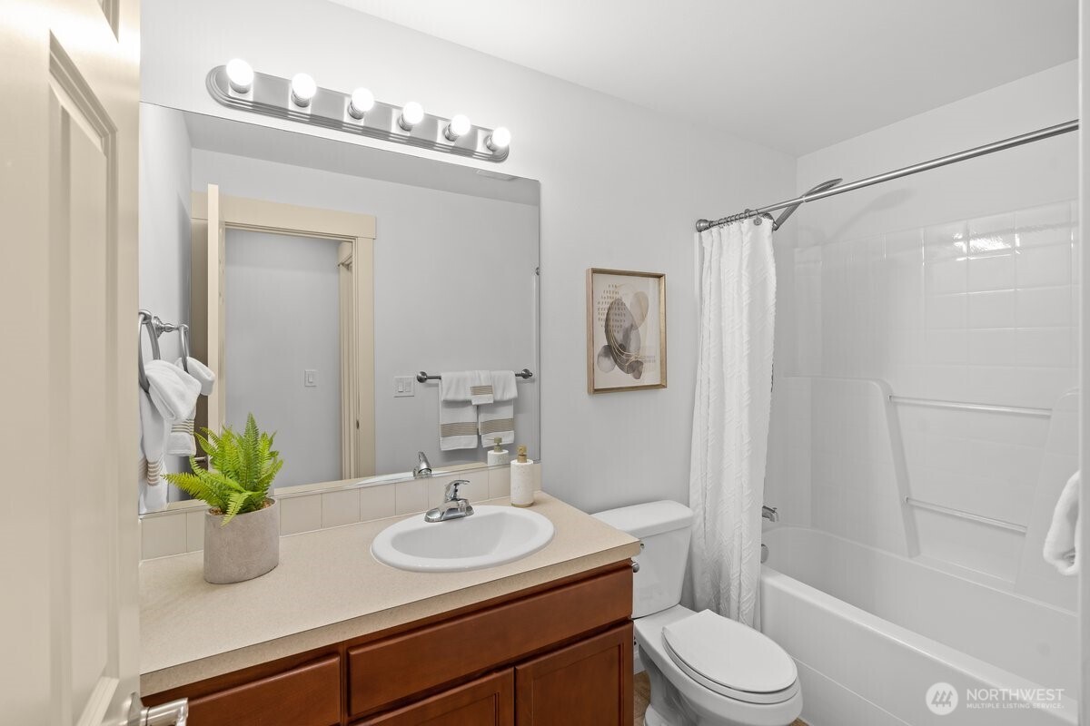 603 194th Place Southeast Bothell, WA 98012 - Photo 23 of 30 a bathroom with a sink a toilet a mirror and shower