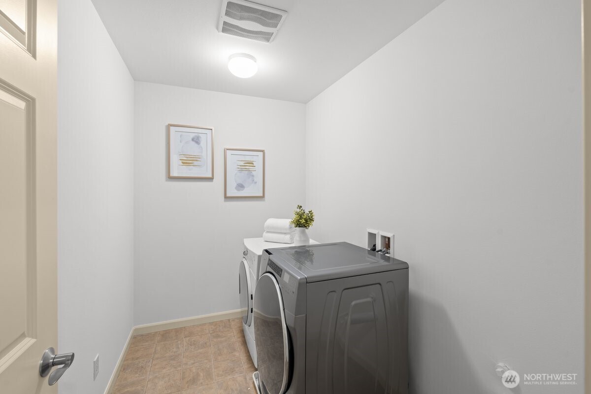 603 194th Place Southeast Bothell, WA 98012 - Photo 26 of 30 a utility room with cabinets and washer dryer