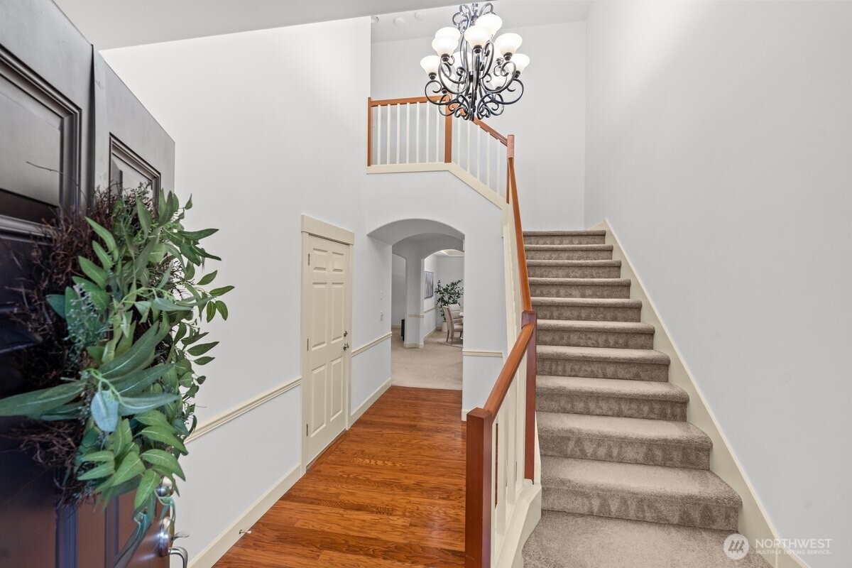 603 194th Place Southeast Bothell, WA 98012 - Photo 3 of 30 a view of a hallway with wooden floor and chandelier