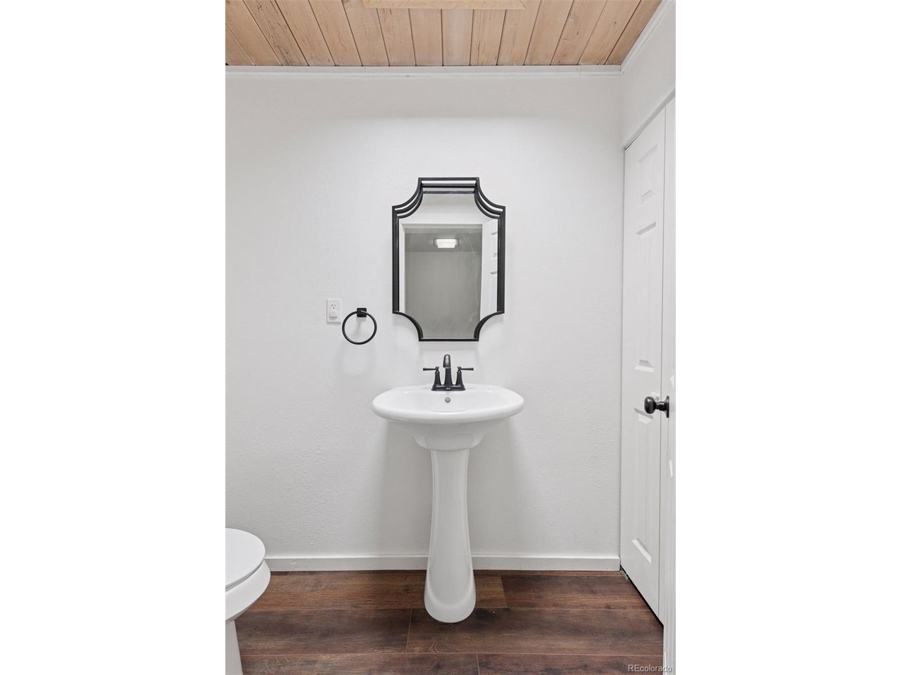 16880 Old Pueblo Road Fountain, CO 80817 - Photo 20 of 49 Half bath featuring pedestal sink, mirror, and overhead lighting.