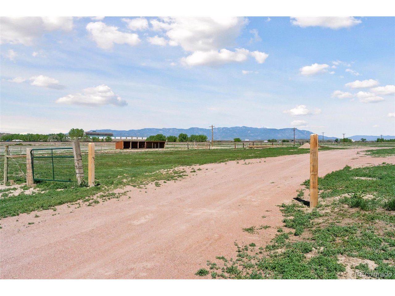 16880 Old Pueblo Road Fountain, CO 80817 - Photo 36 of 49 Mountain-view outlook near the shared access road, with distant views toward Pikes Peak International Speedway across I-25 and the surrounding open landscape