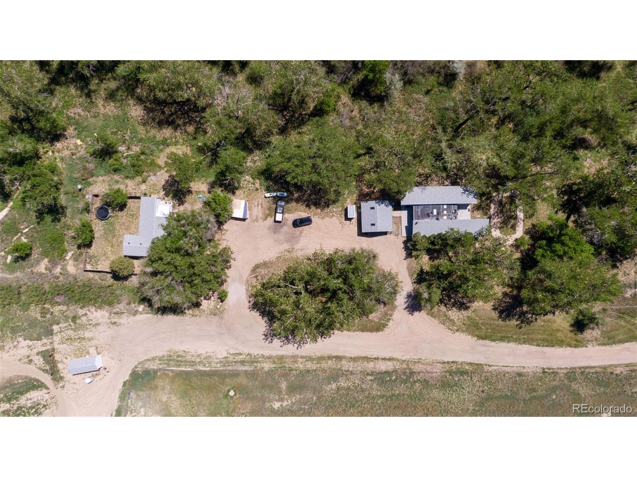16880 Old Pueblo Road Fountain, CO 80817 - Photo 4 of 49 Overhead view of the two existing single-family residences nestled within mature trees, showing internal access, separation, and flexibility for on-site use or management.