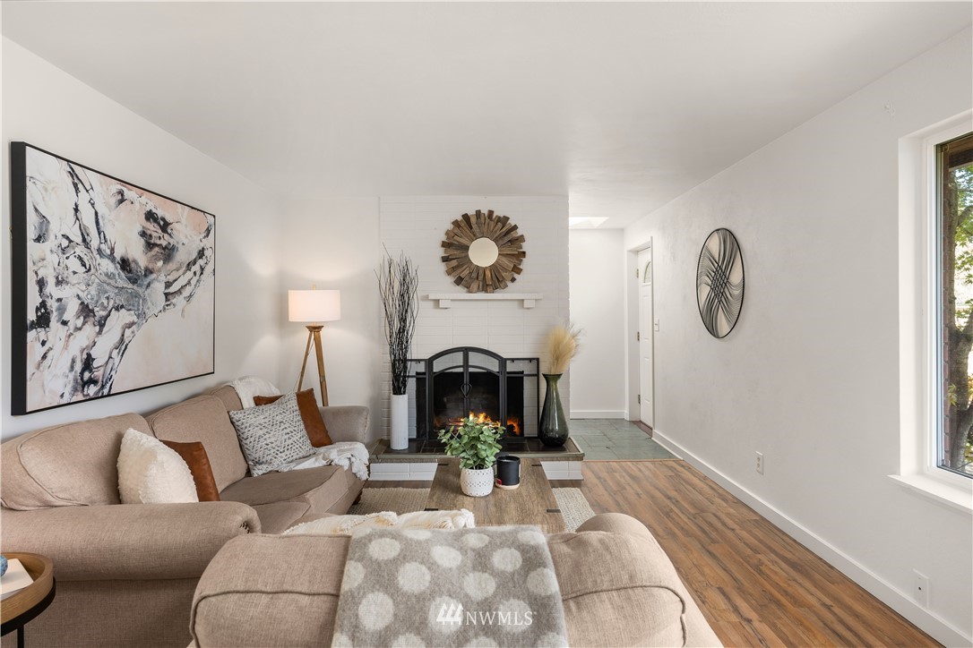 451 Index Avenue Northeast Renton, WA 98056 - Photo 5 of 30 a living room with furniture a fireplace and wall painting