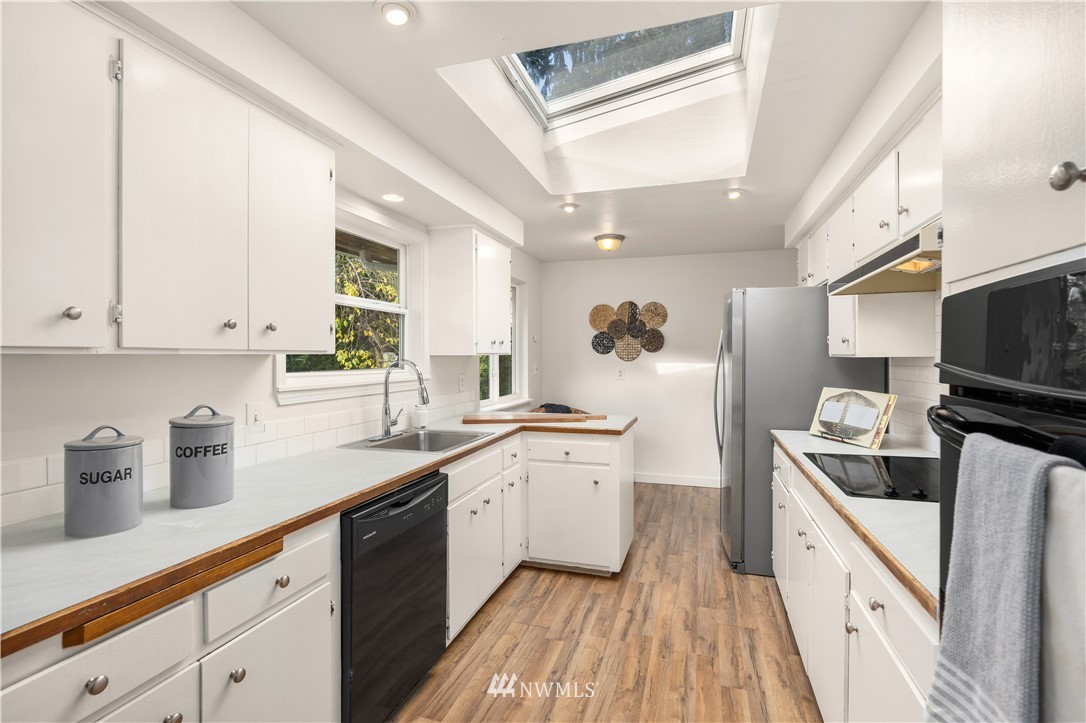 451 Index Avenue Northeast Renton, WA 98056 - Photo 8 of 30 a kitchen with a sink dishwasher stove and refrigerator
