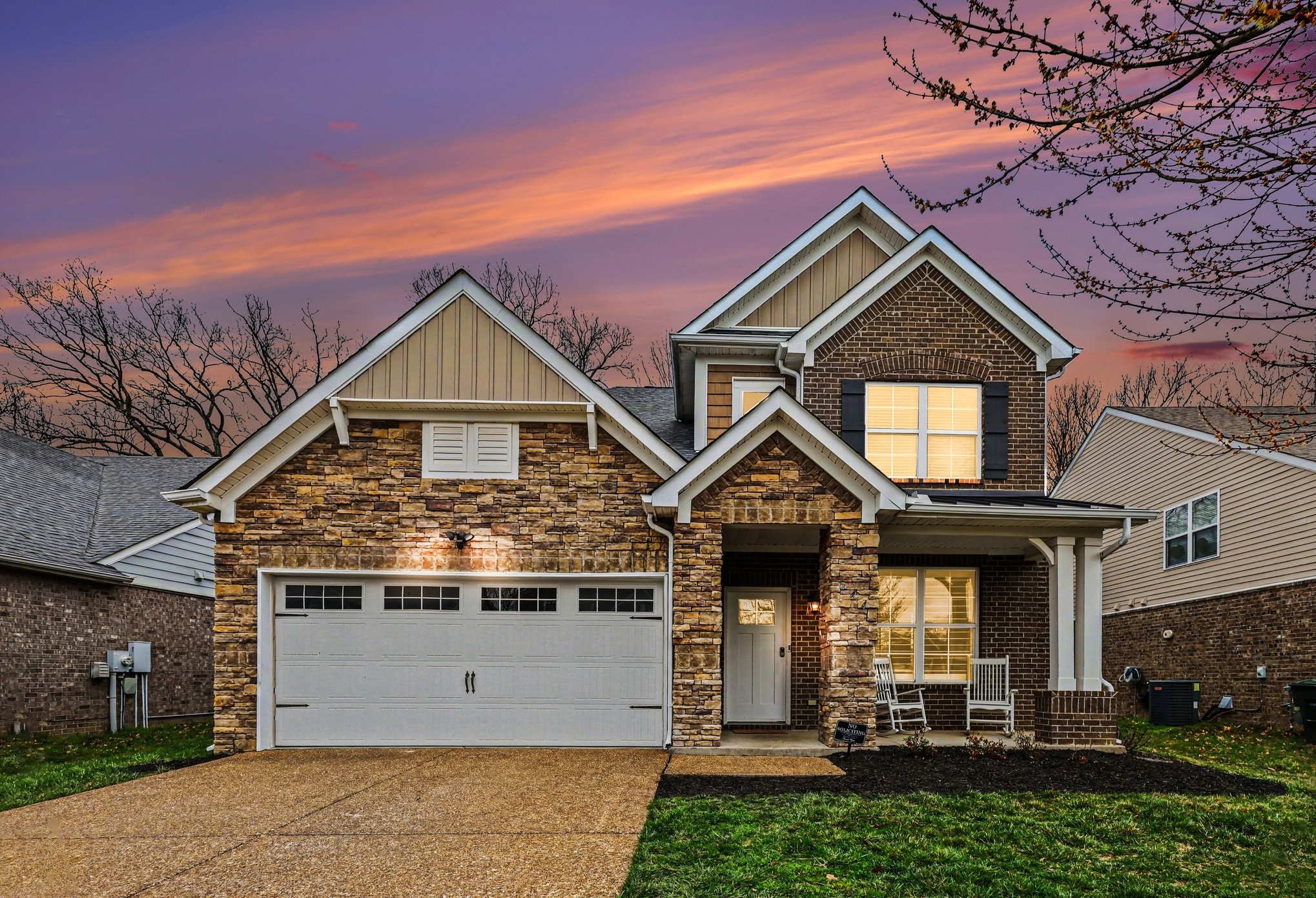a front view of a house with a yard