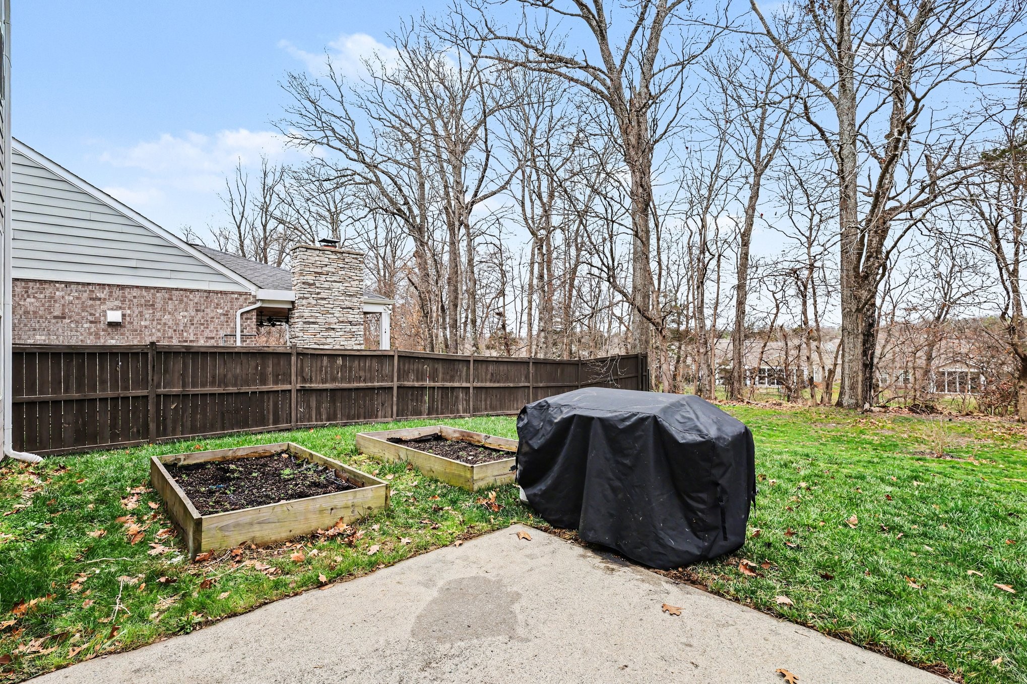 744 Bench Lane Mount Juliet, TN 37122 - Photo 20 of 27 a view of a backyard with a large tree and wooden fence