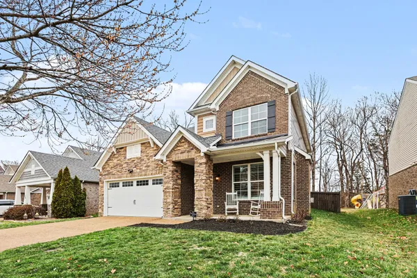 a front view of a house with a yard