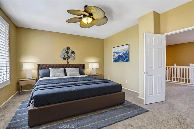 a bedroom with a bed and painting on the wall