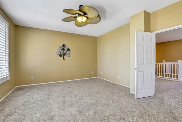 an empty room with a dining space and chandelier