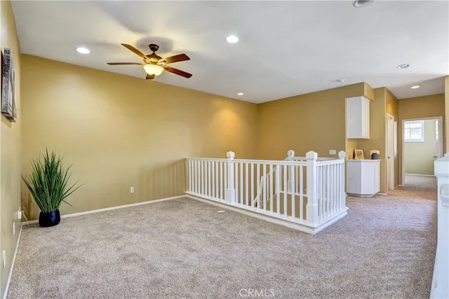 a view of livingroom and dinning room with a ceiling fan