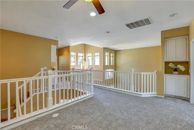 a view of a bedroom with furniture and windows