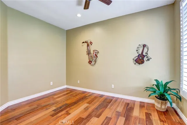 a view of a room with wooden floor and table