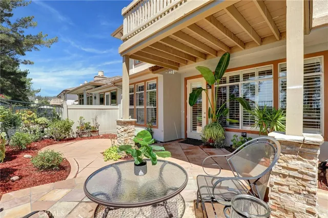 a view of a house with backyard and sitting area