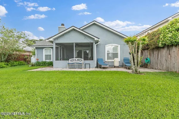 a front view of house with yard and green space