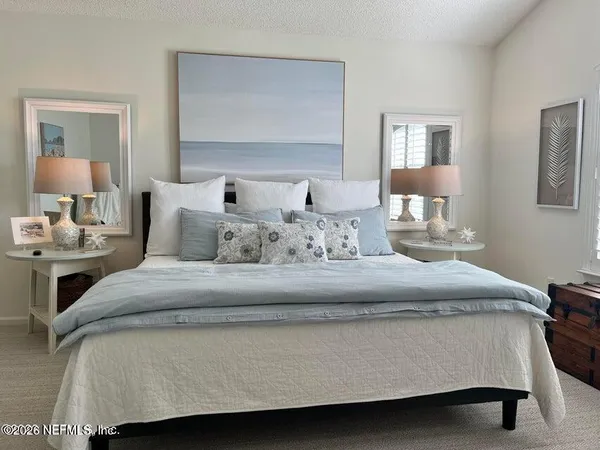 a bedroom with a bed and a lamp