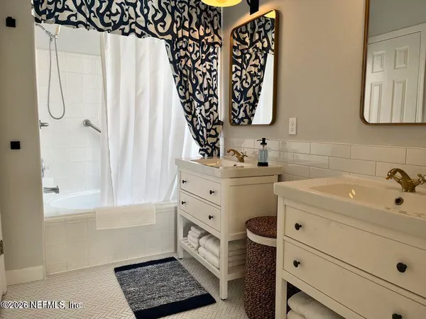 a bathroom with a sink a mirror and a shower curtain
