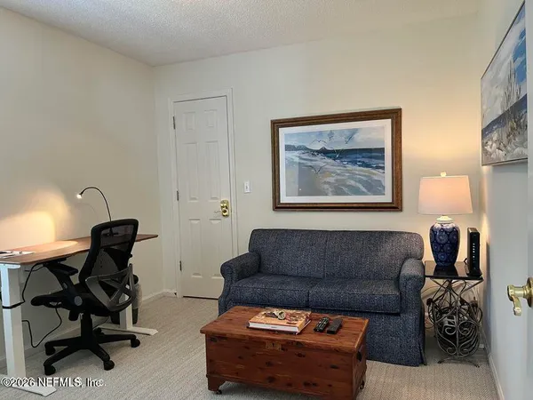a living room with furniture and a piano