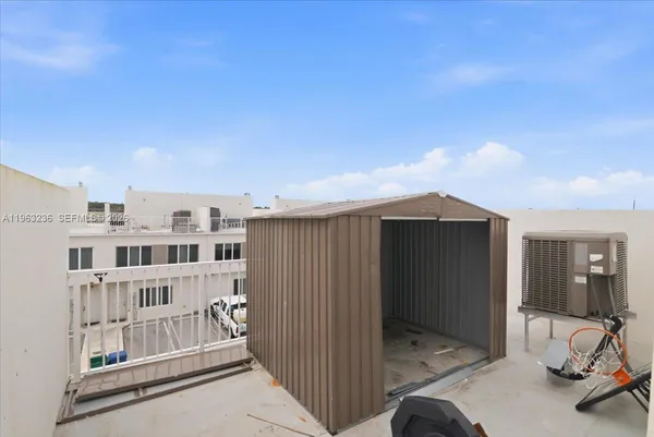 a view of a balcony with furniture