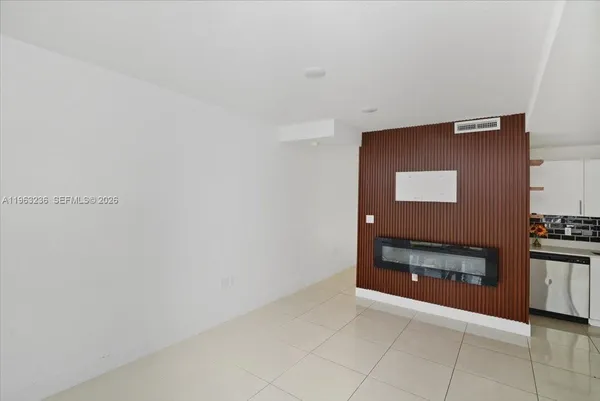 a view of an empty room and fire place