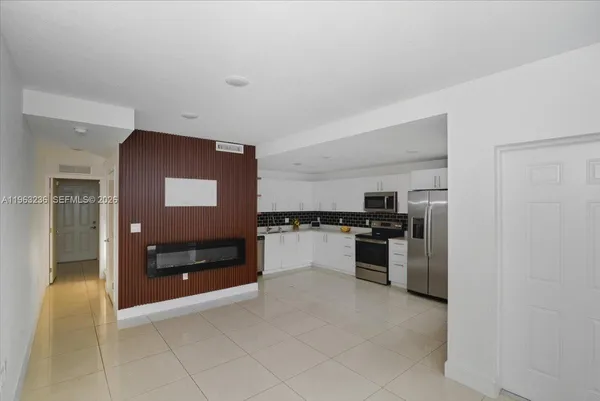 a kitchen with stainless steel appliances granite countertop a refrigerator and stove top oven
