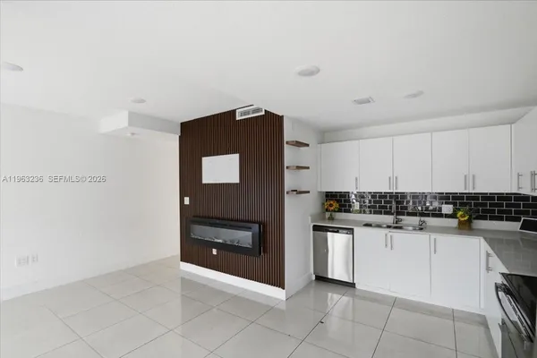 a kitchen with granite countertop a stove and a sink