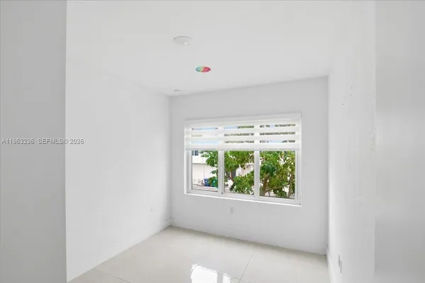 a view of an empty room with a window