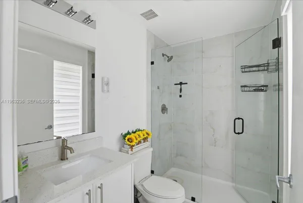 a bathroom with a sink toilet and shower