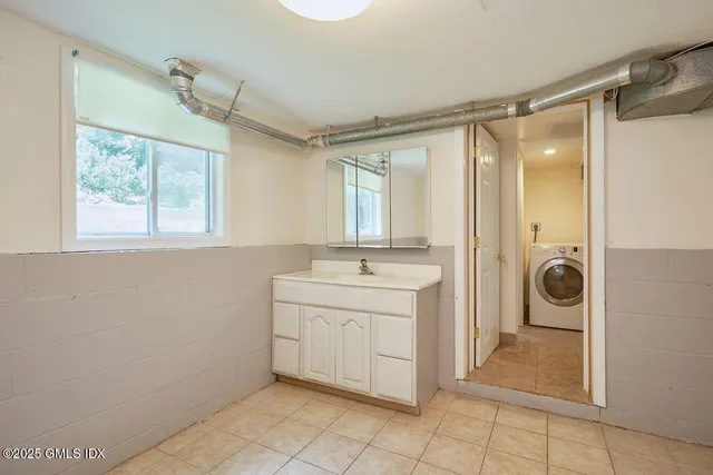 a bathroom with a sink a mirror and a shower