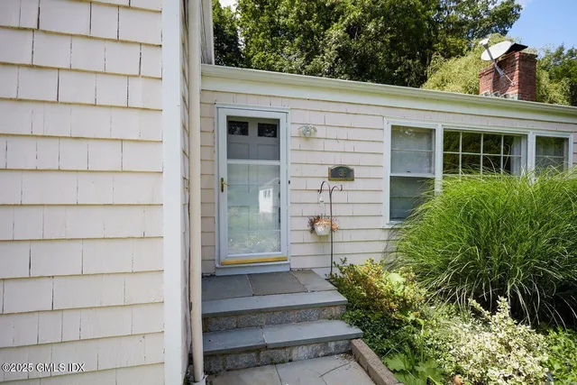 a front view of a house with a garden