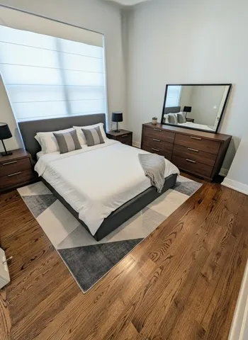 a bedroom with bed and window