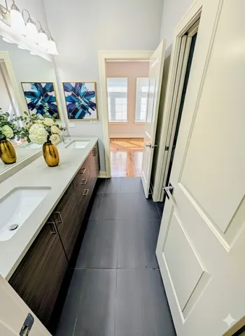 a bathroom with a sink a mirror and shower