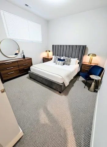 a bed room with a bed and dresser