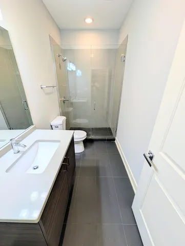a bathroom with a double vanity sink toilet and shower