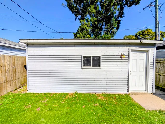 a view of a white house next to a yard