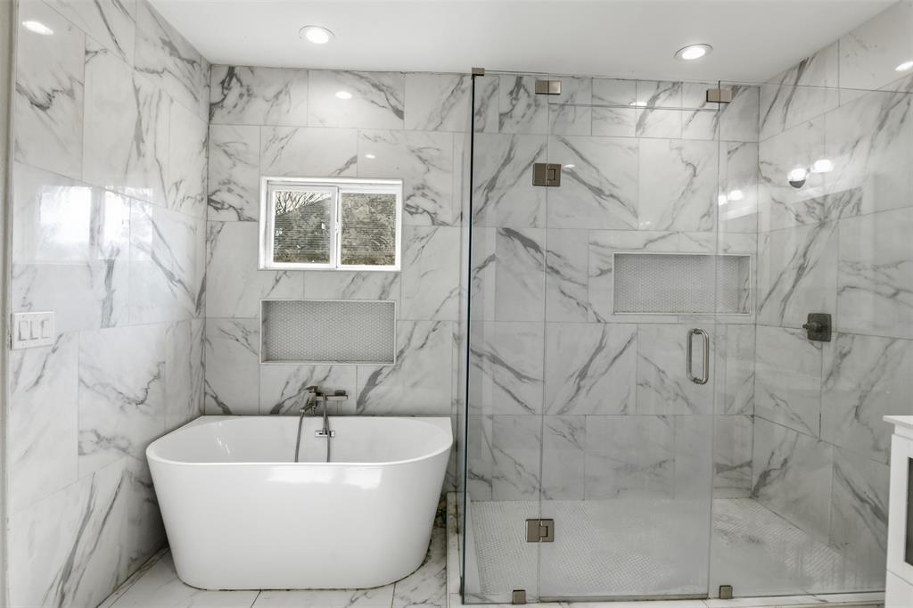2204 Albert Broadfoot Street Bonham, TX 75418 - Photo 15 of 39 a bathroom with a bathtub and shower