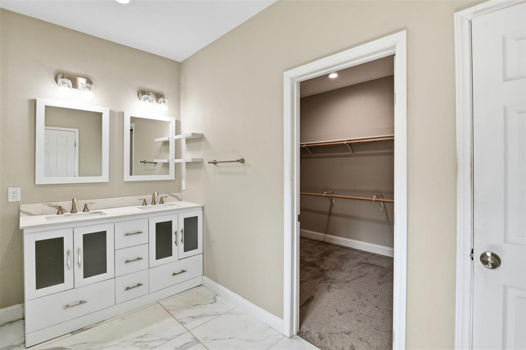 2204 Albert Broadfoot Street Bonham, TX 75418 - Photo 16 of 39 a bathroom with a sink and a mirror
