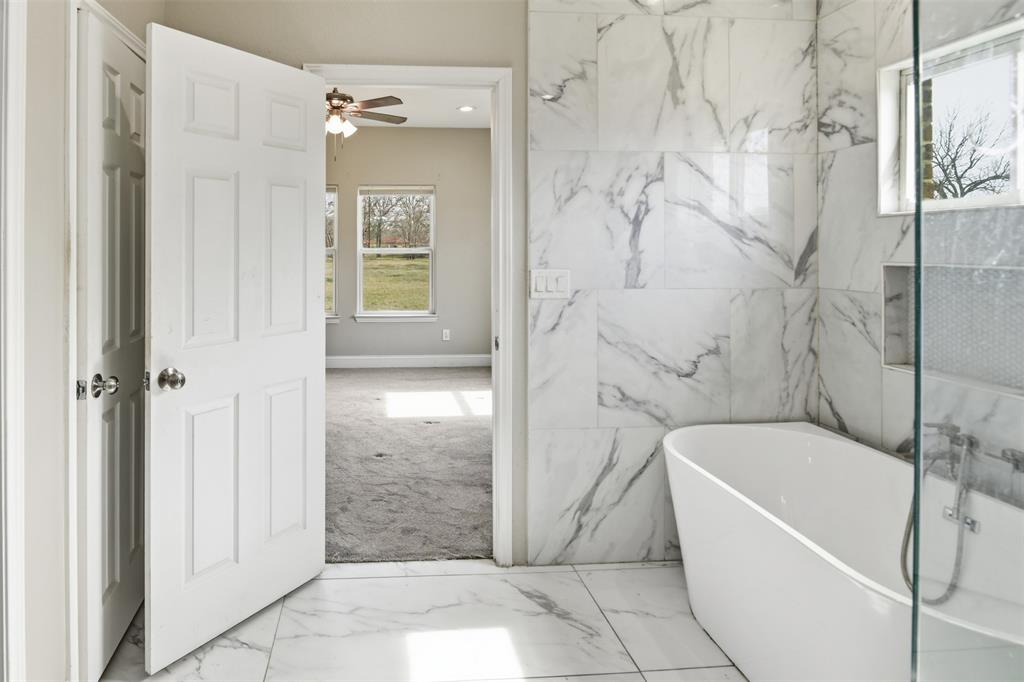2204 Albert Broadfoot Street Bonham, TX 75418 - Photo 17 of 39 a bathroom with a bathtub and shower