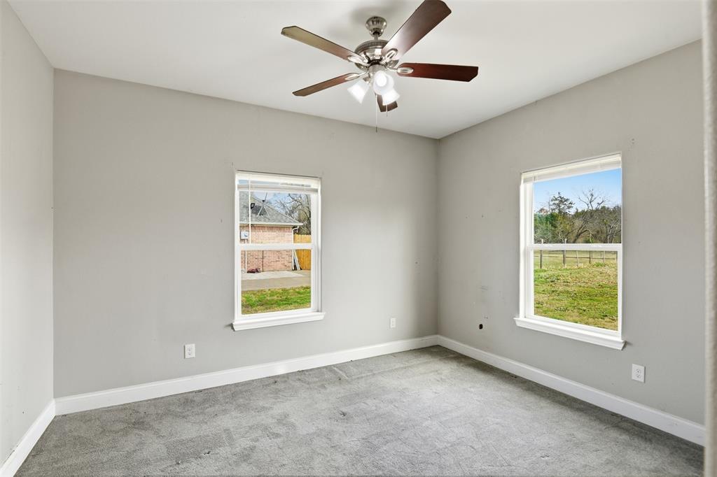2204 Albert Broadfoot Street Bonham, TX 75418 - Photo 21 of 39 an empty room with windows and fan
