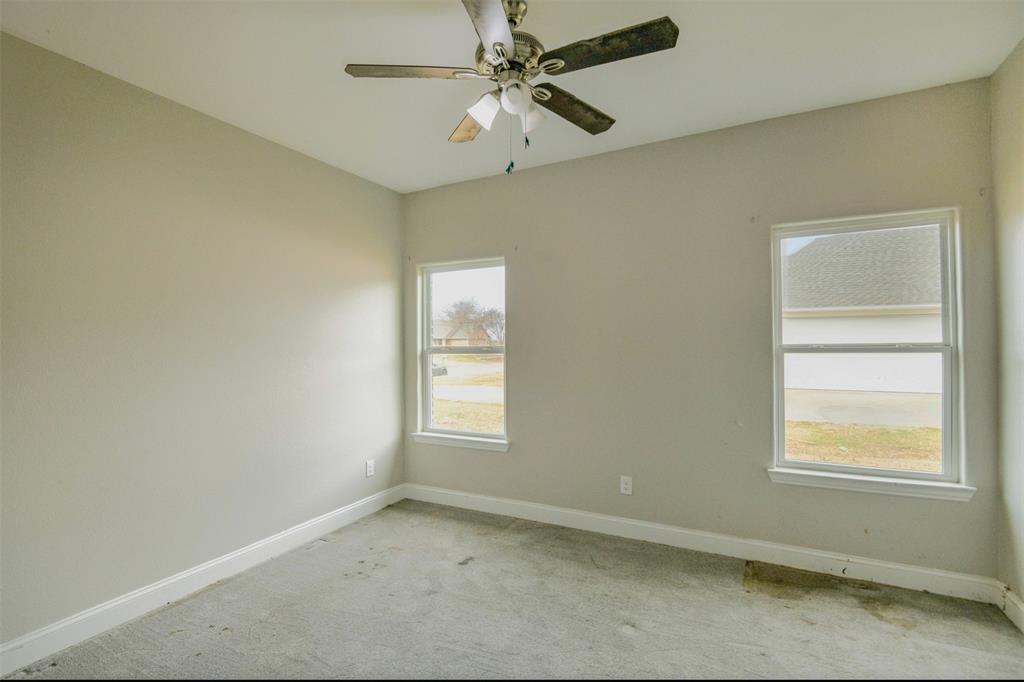 2204 Albert Broadfoot Street Bonham, TX 75418 - Photo 25 of 39 an empty room with windows and fan