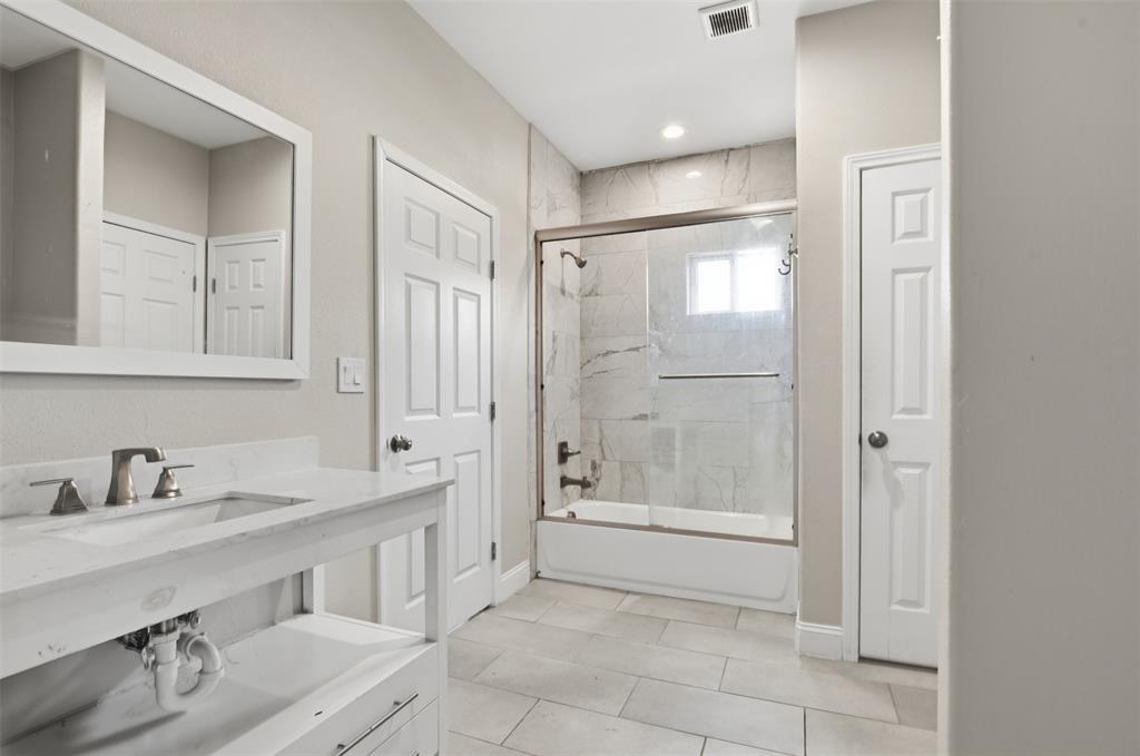 2204 Albert Broadfoot Street Bonham, TX 75418 - Photo 28 of 39 a bathroom with a sink a toilet and shower