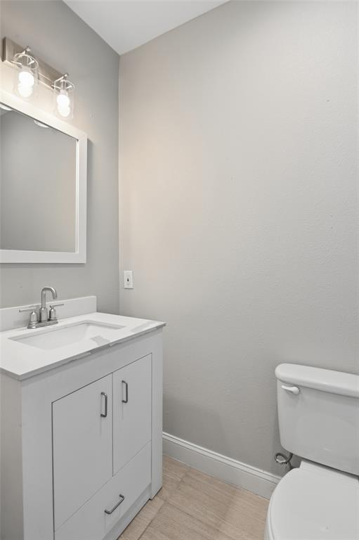 2204 Albert Broadfoot Street Bonham, TX 75418 - Photo 29 of 39 a bathroom with a granite countertop toilet and sink