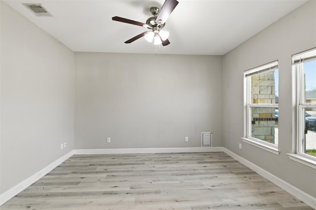 2204 Albert Broadfoot Street Bonham, TX 75418 - Photo 6 of 39 wooden floor in an empty room with a window