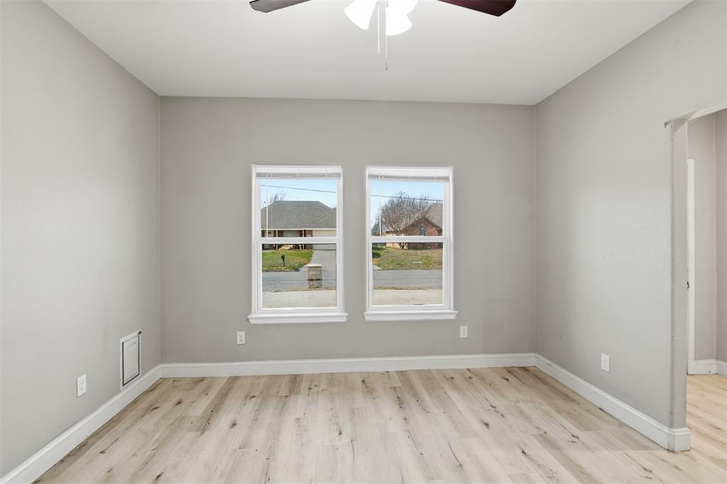 2204 Albert Broadfoot Street Bonham, TX 75418 - Photo 7 of 39 an empty room with wooden floor and windows