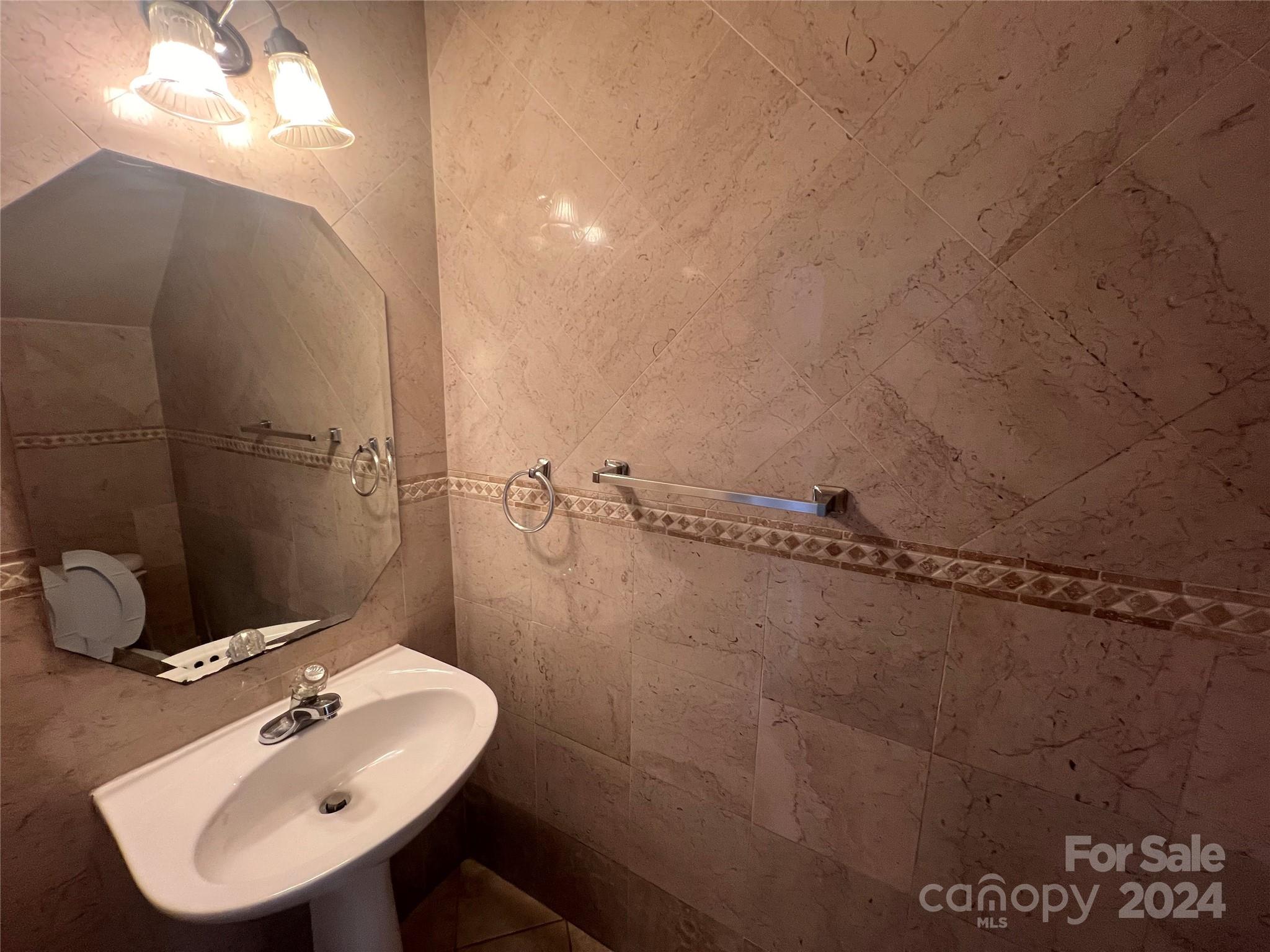 1022 Breakmaker Lane Indian Trail, NC 28079 - Photo 11 of 20 a bathroom with a sink and mirror