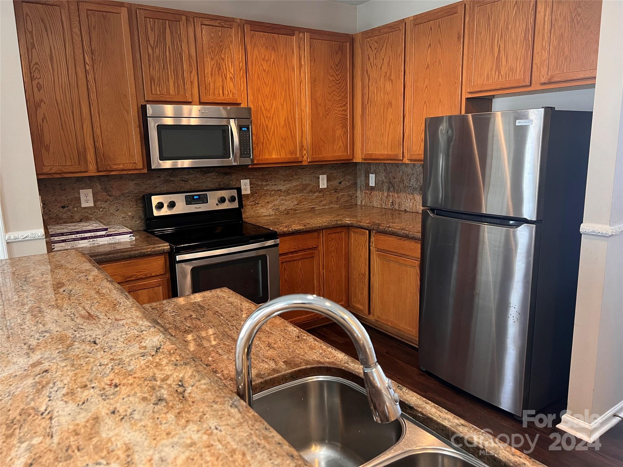 1022 Breakmaker Lane Indian Trail, NC 28079 - Photo 2 of 20 a kitchen with stainless steel appliances granite countertop a refrigerator stove and microwave