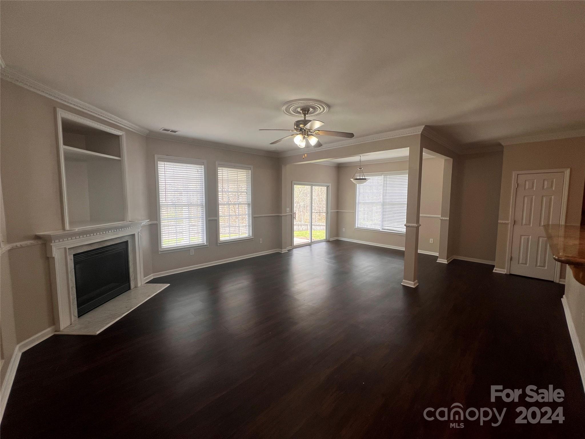 1022 Breakmaker Lane Indian Trail, NC 28079 - Photo 3 of 20 a view of an empty room with a fireplace and a window