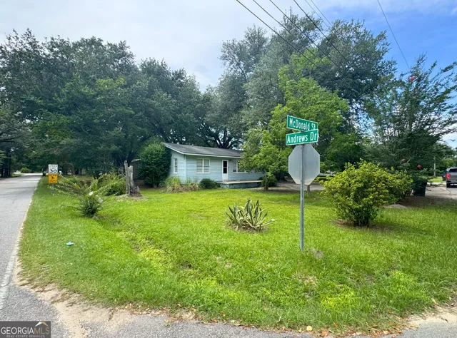 a swimming pool with plants and large trees