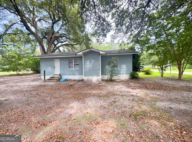a front view of house with yard and green space