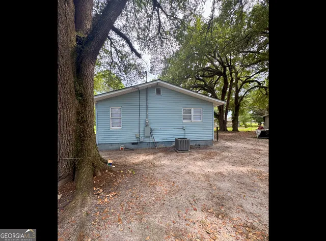 a backyard of a house with large trees